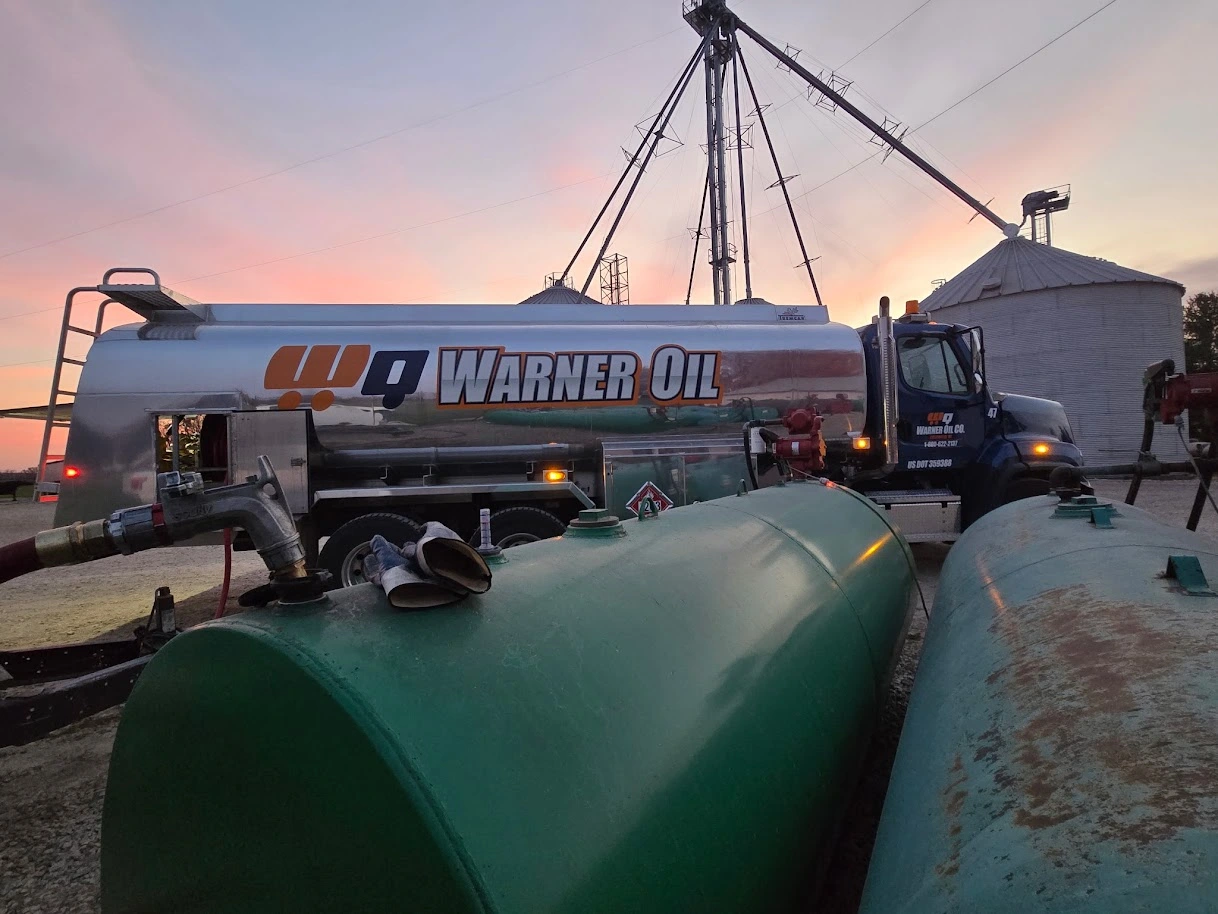 WEB WOC New bulk fuel truck fueling bulk tanks with silos in background